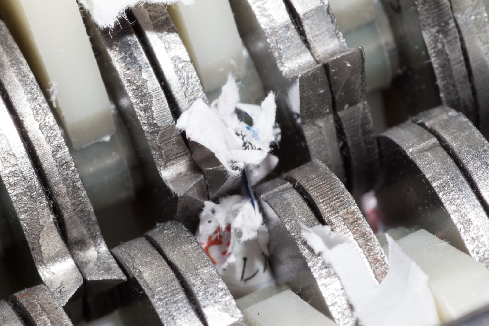 Jammed Shredder Scraps Between Paper Shredder Blades