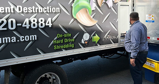 Shredding cart being lifted up by the shredding truck