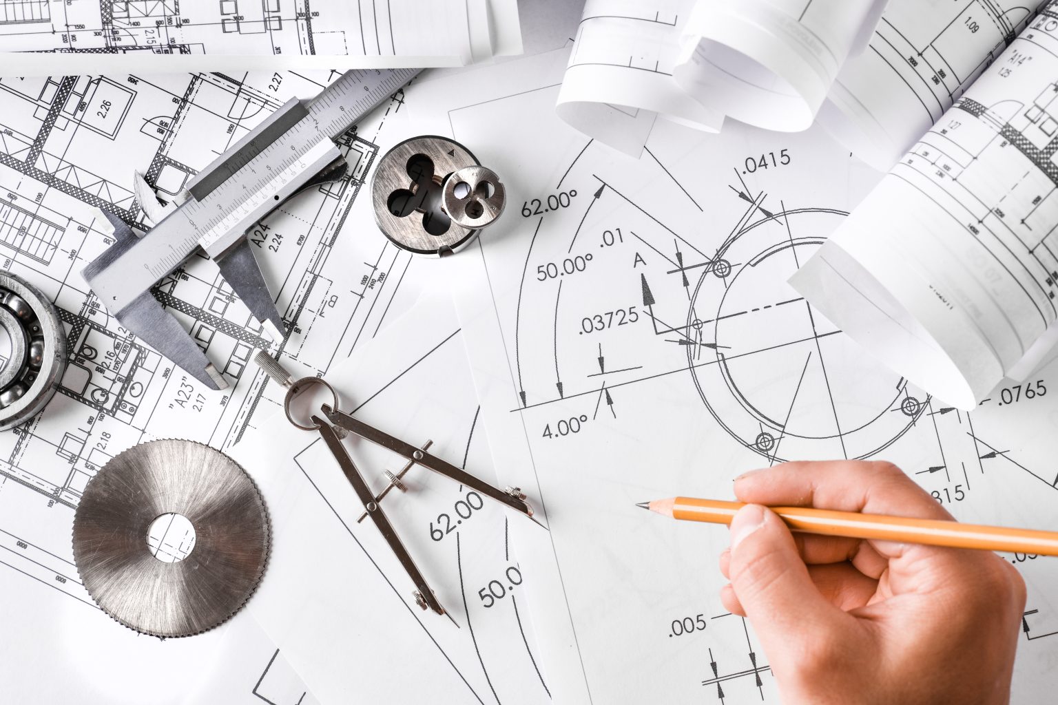 Engineer technical drawings and mechanical parts engineering industry work project paper prints.